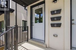 Windsor apartment for rent - A white door is on the right side of a black railing.