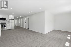 Windsor apartment for rent - A spacious, empty room with wooden flooring and white walls.