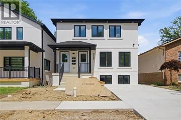 Windsor apartment for rent - A modern two-story house with a realtor sign on the front.