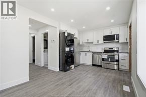 Windsor apartment for rent - A modern kitchen with white cabinets and stainless steel appliances.