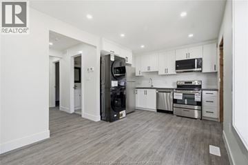 Windsor apartment for rent - A modern kitchen with white cabinets and stainless steel appliances.