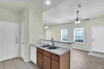 Midlothian apartment for rent - A kitchen with a sink, a counter, and a ceiling fan.
