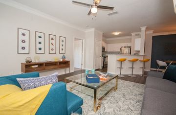 Stockbridge apartment for rent - A living room with a blue couch and a glass coffee table.