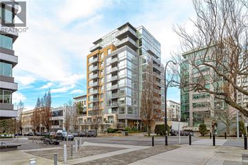 Victoria apartment for rent - A modern apartment building with a parking lot in front.
