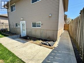 Hamilton (Stoney Creek Mountain) apartment for rent - A house with a white door and a small window is shown.