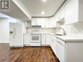 Hamilton (Stoney Creek Mountain) apartment for rent - A kitchen with white appliances and cabinets.