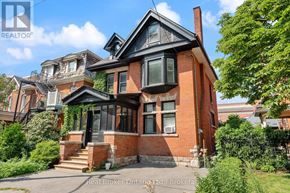 Hamilton (Durand) multi-family for rent - A red brick house with a black window and a chimney.