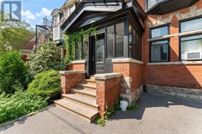 Hamilton (Durand) multi-family for rent - A house with a black front door and a brick wall.