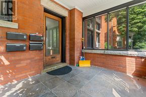 Hamilton (Durand) multi-family for rent - A red brick house with a black mailbox and a yellow bag on the door mat.