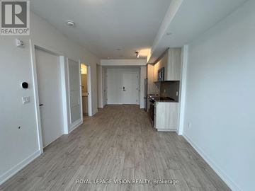 Milton (Cb Cobban) condo for rent - A long hallway with a kitchen area on the right.