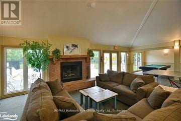 Blue Mountains townhouse for rent - A living room with a pool table and a fireplace.