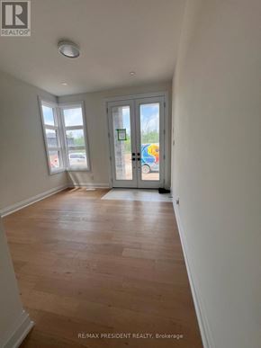 Niagara Falls (Marineland) apartment for rent - A room with wooden flooring and a sliding glass door.