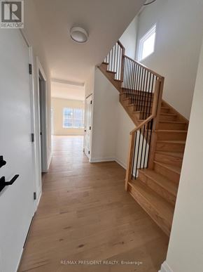 Niagara Falls (Marineland) apartment for rent - A hallway with a staircase and a door on the left.