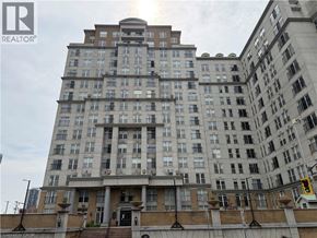 Hamilton condo for rent - A tall building with a flat roof and a balcony with a railing.