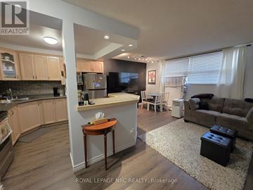 St. Catharines (Oakdale) condo for rent - A well-lit kitchen and living room with a couch and a coffee table.