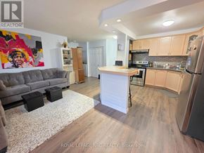 St. Catharines (Oakdale) condo for rent - A kitchen with a refrigerator, oven, and sink.