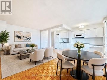 Toronto (Annex) condo for rent - A well-lit dining room with a round table surrounded by chairs.