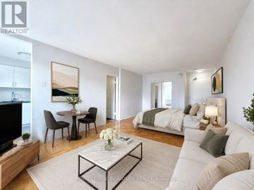 Toronto (Forest Hill South) condo for rent - A living room with a black sofa and a coffee table.