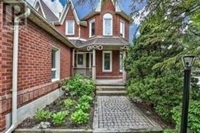 Markham (Buttonville) apartment for rent - A red brick house with a front yard and a lamp post.