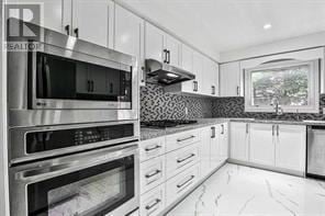 Markham (Buttonville) apartment for rent - A modern kitchen with white cabinets and stainless steel appliances.