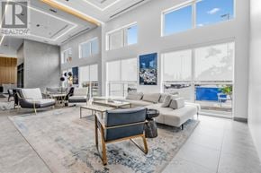 Oakville (Go Glenorchy) condo for rent - A modern living room with a large sofa, a coffee table, and a view of the outdoors through the windows.