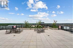 Oakville (Go Glenorchy) condo for rent - A rooftop patio with a view of the water and sky.