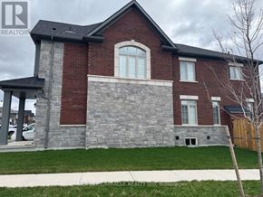 Erin apartment for rent - A brick house with a stone wall in front.
