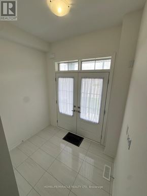Erin apartment for rent - A white tiled room with a door and a window.