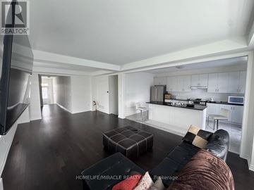 Erin apartment for rent - A living room with a brown couch and a black coffee table.