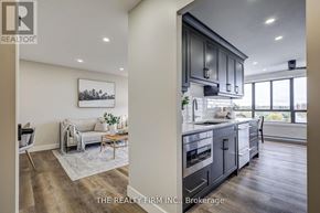 London South (South D) condo for rent - A modern kitchen with dark wood cabinets and a large island.