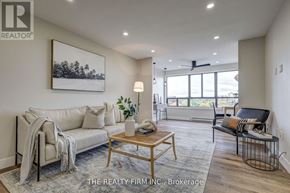 London South (South D) condo for rent - A living room with a couch, a chair, a coffee table, and a painting on the wall.