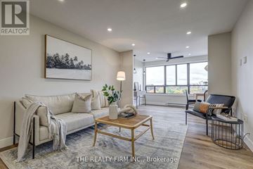 London South (South D) condo for rent - A living room with a couch, a chair, a coffee table, and a painting on the wall.