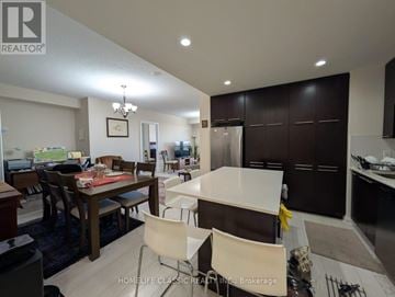 Toronto (Willowdale East) condo for rent - A modern kitchen with a dining table and chairs.