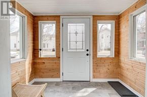 Guelph (Downtown) duplex for rent - A white door with a diamond pattern in the middle is the focal point of this image.