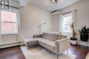 Guelph (Downtown) duplex for rent - A living room with a beige couch and a rug.