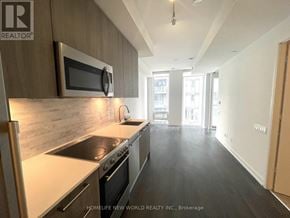 Toronto (Church-Yonge Corridor) condo for rent - A kitchen with a stove top oven and microwave above it.