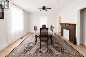 Barrie (City Centre) apartment for rent - A dining room with a rug, chairs, and a fireplace.