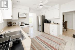 Barrie (City Centre) apartment for rent - A kitchen with white cabinets and a stainless steel refrigerator.