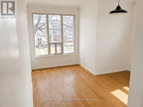 Hamilton (Eastmount) multi-family for rent - A room with a window showing a snowy scene outside.