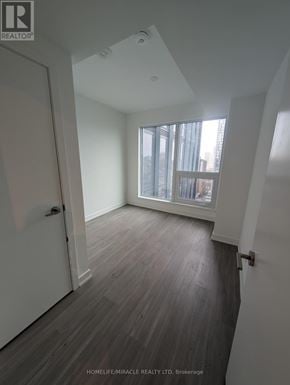 Toronto (Bay Street Corridor) condo for rent - A room with a window and wooden flooring.