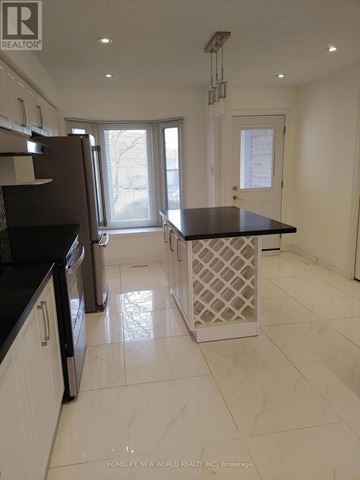 Markham (Raymerville) apartment for rent - A kitchen with white cabinets and black countertops.
