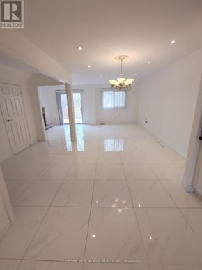 Markham (Raymerville) apartment for rent - A spacious room with white tiled flooring and a chandelier hanging from the ceiling.