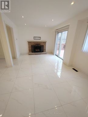 Markham (Raymerville) apartment for rent - A spacious room with a fireplace and a marble floor.