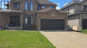 London North (North F) apartment for rent - A house with a garage and a driveway in front of it.