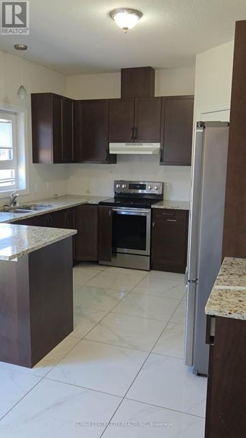 London North (North F) apartment for rent - A kitchen with brown cabinets and a white counter.