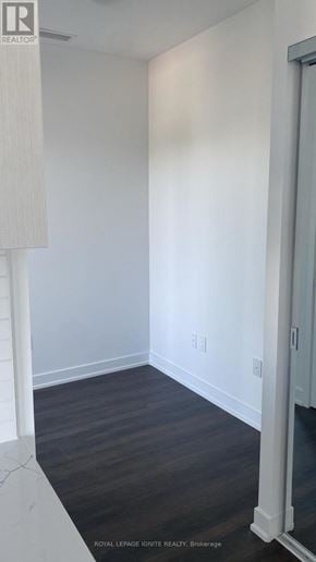 Burlington (Brant) condo for rent - A white room with a wooden floor and a white door.