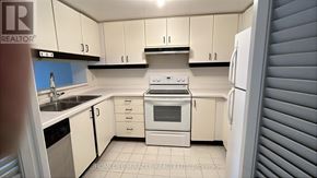Toronto (Bay Street Corridor) condo for rent - A kitchen with white cabinets and appliances.