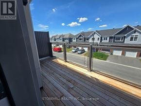 Ottawa townhouse for rent - A view from a balcony overlooking a residential street.