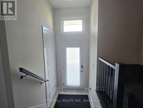 Ottawa townhouse for rent - A hallway with a door and a window.