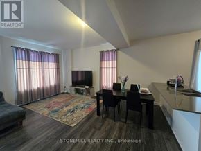 Ottawa townhouse for rent - A living room with a couch, chairs, and a television.